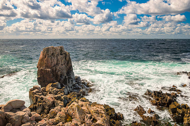 A sheltered cove surrounded by rugged cliffs and and colourful historic buildings offering a glimpse into Newfoundland seafaring past.