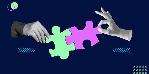 istock Abstract artwork of two hands connecting colorful puzzle pieces, symbolizing teamwork and collaboration. Ideal for leadership, partnership and corporate strategy. Minimalist art collage. 2212719233