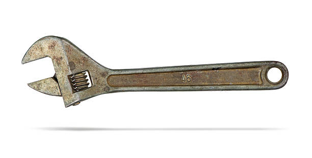 An old rust-covered large adjustable wrench, isolated on white background. File contains a path to isolation. stock photo