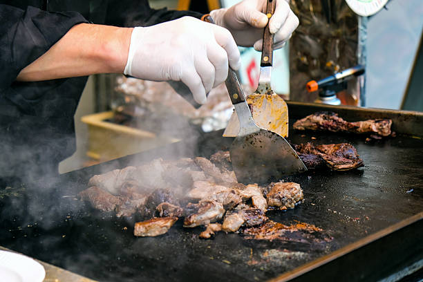 istock Chef cooking beef steak on a hot pan in a restaurant kitchen 2212722289