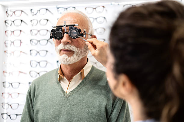 istock Ophthalmologist examining senior man diopter with optometrist trial frame. 2212723186