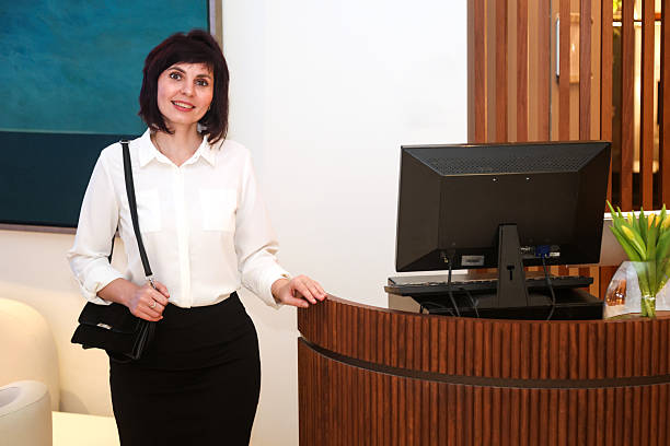 istock An office worker stands near her workstation with a computer on her desk 2212723483