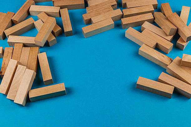 istock Wooden blocks scattered on a bright blue surface 2212724593
