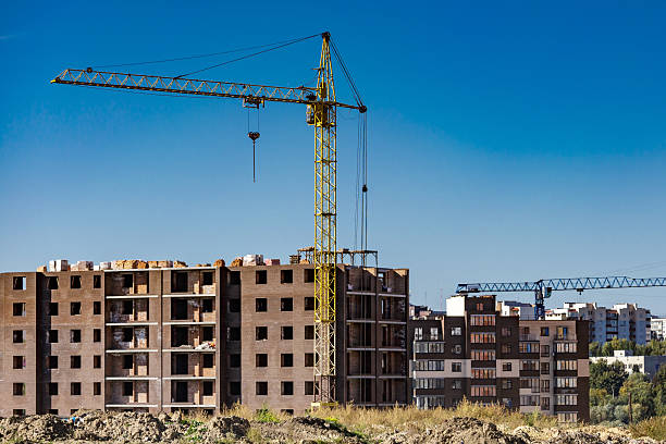istock Extensive scaffolding providing platforms for work in progress on a new apartment block,Tall building under construction with scaffolds,Construction Site of New Building 2212724687