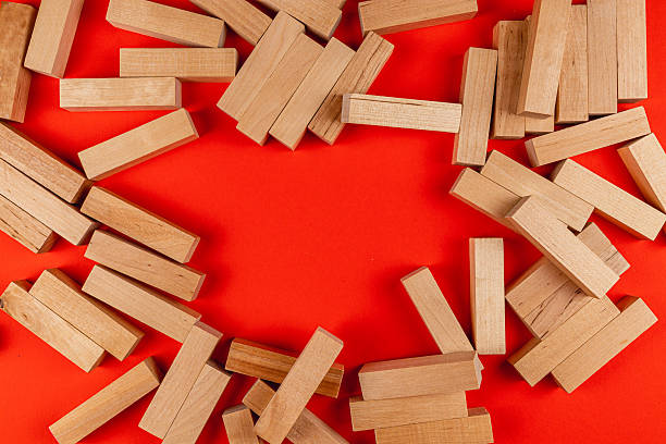 istock Wooden blocks scattered on vibrant red background 2212725068