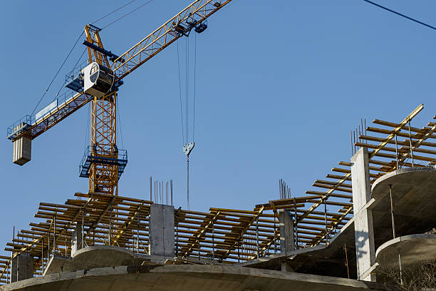 istock Extensive scaffolding providing platforms for work in progress on a new apartment block,Tall building under construction with scaffolds,Construction Site of New Building 2212725074
