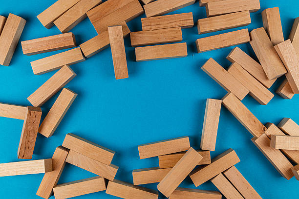 istock Wooden blocks scattered on a blue surface for creative play 2212725187
