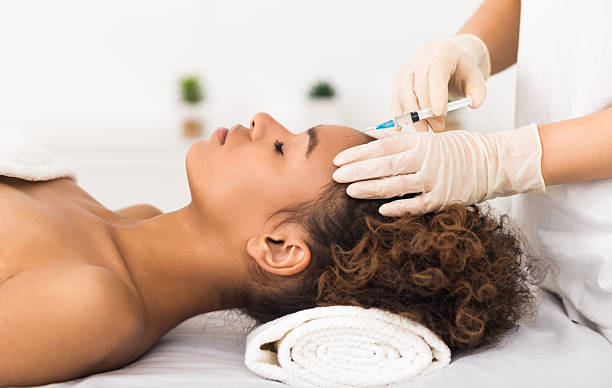 istock Aesthetic surgery. Woman having injection on forehead 2212726207