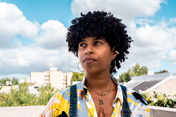 istock Young woman contemplating on rooftop 2212727595