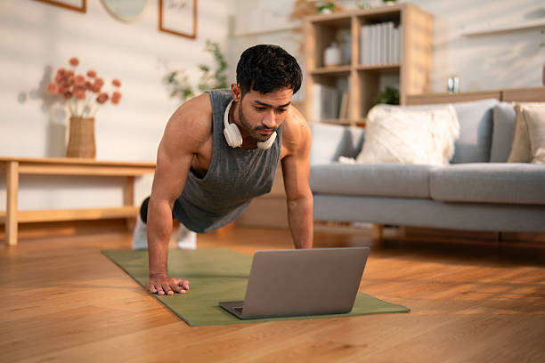 istock Athletic man doing high plank workout at home 2212729586