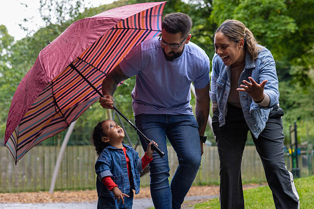 istock Toddler Enjoying the Rain Under Cover 2212730531