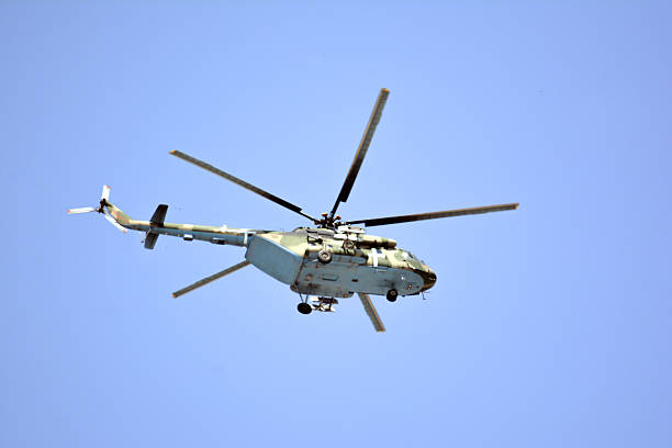 istock Helicopter flying. Helicopter with a blue sky in the background 2212731154