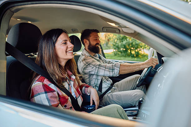 istock Couple driving and smiling during a road trip 2212731357