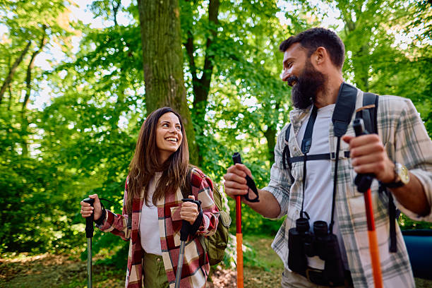 istock Hikers couple exploring forest using trekking poles and backpacks 2212731377