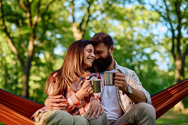 istock Couple relaxing in hammock, drinking coffee and enjoying nature 2212732089
