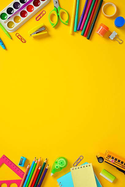 istock Back to school supplies flat lay on yellow background. Top and bottom border 2212733507