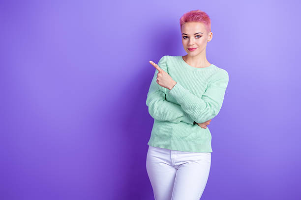 istock Photo of nice positive young lady indicate finger empty space advert proposition blank isolated on violet color background 2212741848