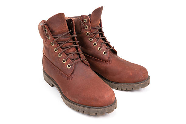 istock Pair of worn brown leather boots isolated on white background. 2212750198