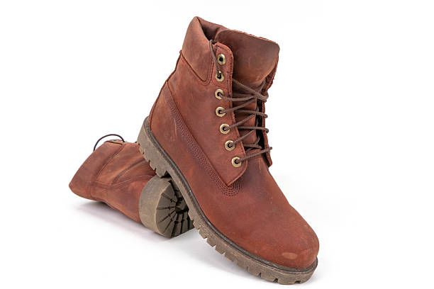 istock Pair of worn brown leather boots isolated on white background. 2212750249