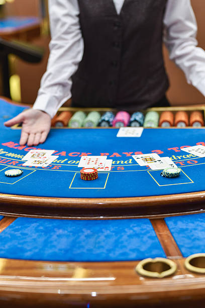 istock Experienced Casino Dealer Setting Up Table For Blackjack Round 2212750457