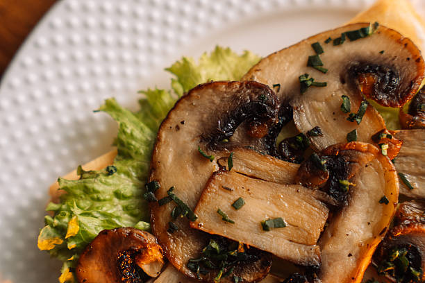 Belgian salty waffles with champignons on white plate.