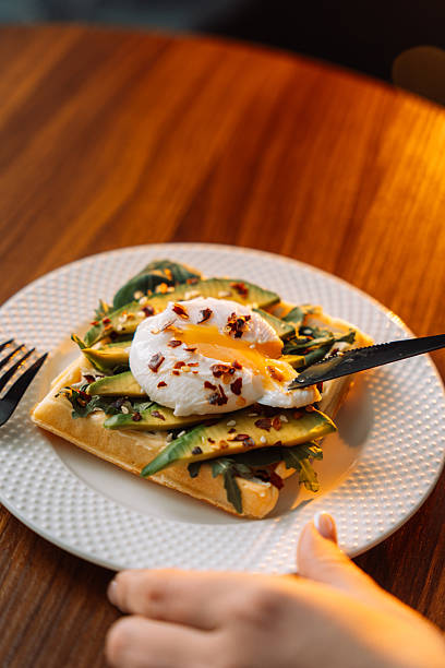 istock waffles with poached egg avocado on plate on wooden background 2212757576