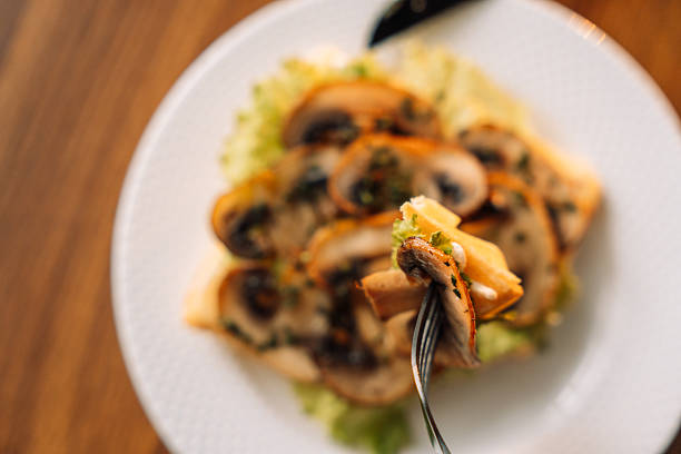 Belgian salty waffles with champignons on white plate.