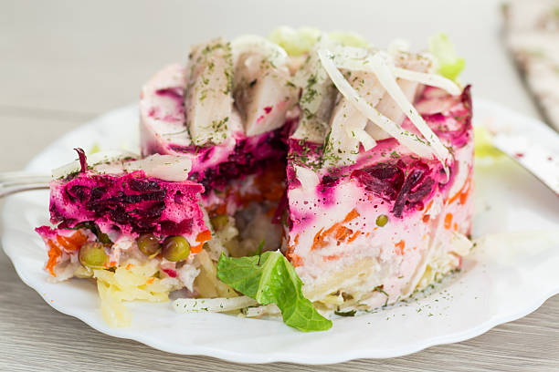 istock layered vegetable salad with beets and herring, on a wooden table 2212758404