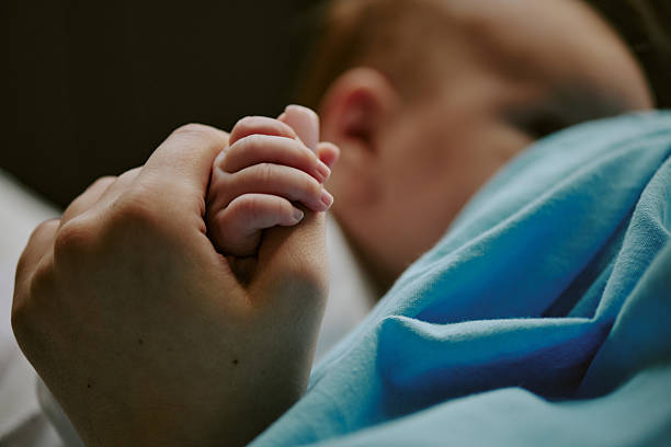 istock Holding Baby's Hand with Gentle Grip 2212759611
