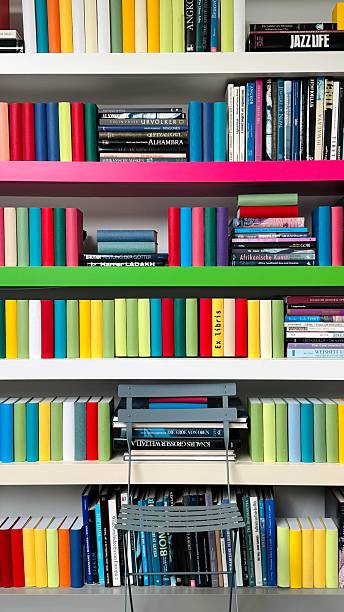 istock Bookshelves tightly packed with many colorful books 2212763072
