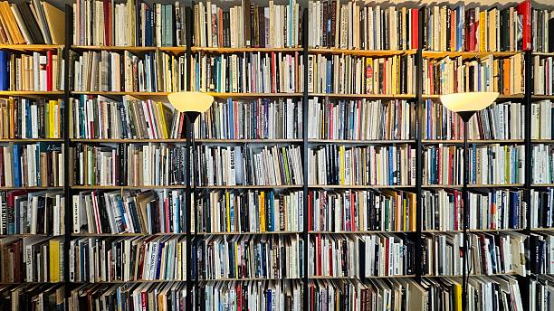 istock Bookshelves tightly packed with many old books 2212763136
