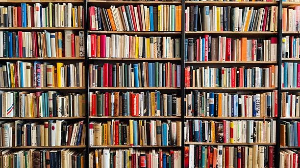 istock Bookshelves tightly packed with many old books 2212764769
