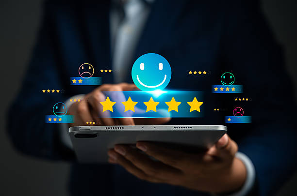 istock Customer using tablet give five star rating, Submit satisfaction survey through online application. Positive feedback highlight excellent service and product quality, improving brand reputation. 2212765299