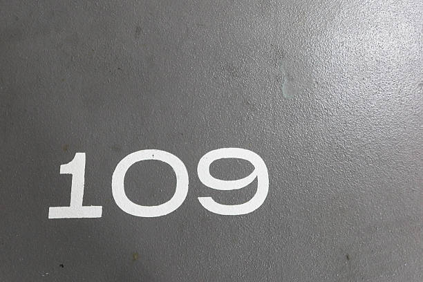 number 109 painted in white on the grey ground with copy space