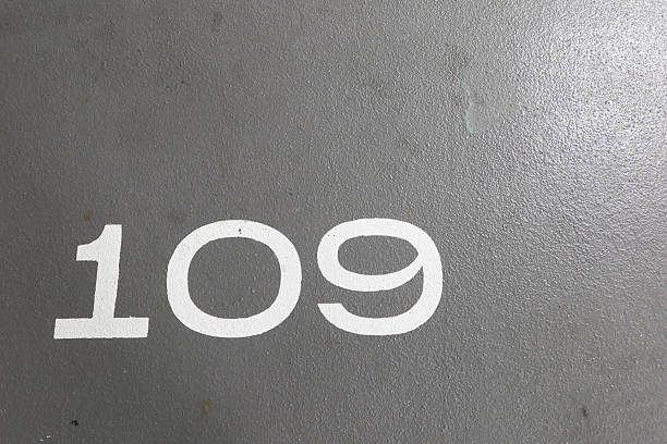 istock number 109 painted in white on the grey ground with copy space 2212765528