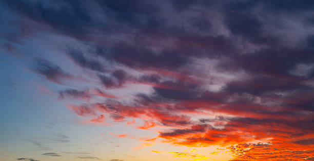 istock Sky at sunset. Sunrise over horizon. Sunset through clouds on sky. Twilight sky with sunset colors. Peaceful dawn with soft light. Dramatic dusk sunset with clouds. Sunshine in clear sky. 2212765612