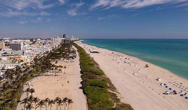 istock Beach in Miami with sunbed on a sandy beach with ocean waves. Miami Beach paradise with stunning views. South Beach Miami lifeguard post. Peaceful seaside retreat in Miami. Coastal relaxation. 2212766086