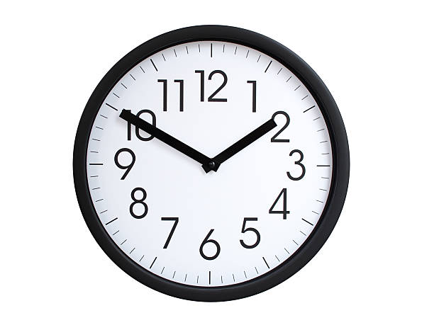 Simple round wall clock with black frame and white face, showing the time exactly at 01:50 or 13:50. Representing time precision in concepts of deadlines.