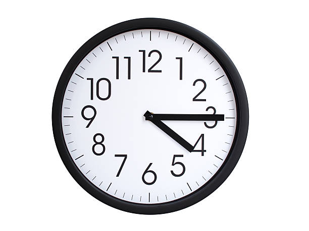 Simple round wall clock with black frame and white face, showing the time exactly at 04:15 or 16:15. Representing time precision in concepts of deadlines.