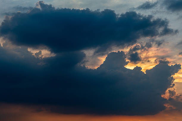 istock The sky is dark and cloudy with a few rays of light peeking through 2212769357