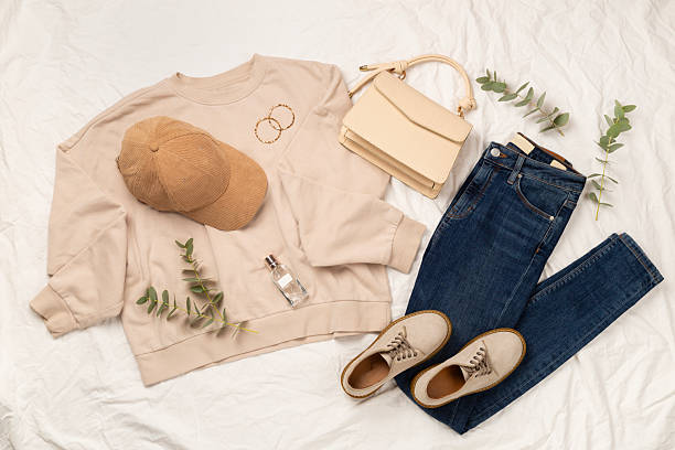 istock Flat lay with women's trendy spring outfit on white sheet background, top view 2212772421
