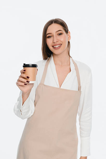 istock Smiling Female Barista Offering Coffee in a Cozy Cafe Setting 2212772498