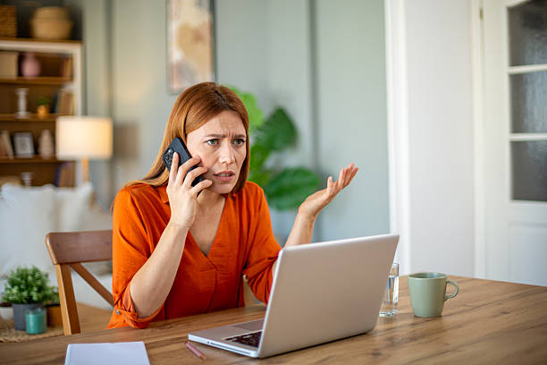 istock Stressed businesswoman arguing on phone while working at home 2212772749