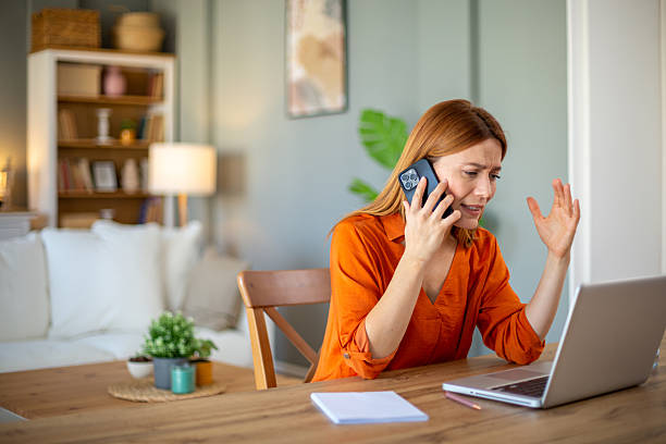 istock Stressed businesswoman having a difficult phone call while working from home 2212773220