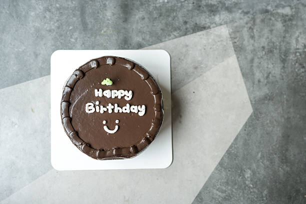A white message saying 'Happy Birthday' on delicious chocolate cake