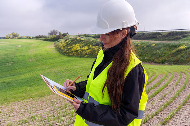 istock Female engineer taking notes on sustainable energy site inspection 2212777792