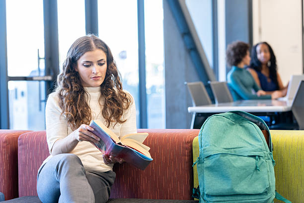 istock University student reads a book in common room on campus 2212777949