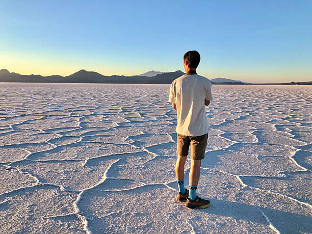 Young man photographer on salt flat