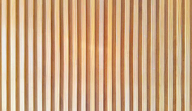 istock uniformly textured surface composed of numerous parallel, light brown wooden slats arranged vertically, creating a clean and simple pattern with subtle variations in tone and shadow. 2212778771