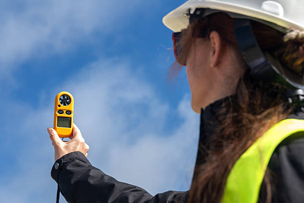 istock Female engineer measuring wind speed for sustainable energy generation 2212779115